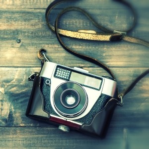 Vintage film camera on wooden background. Instagram style
